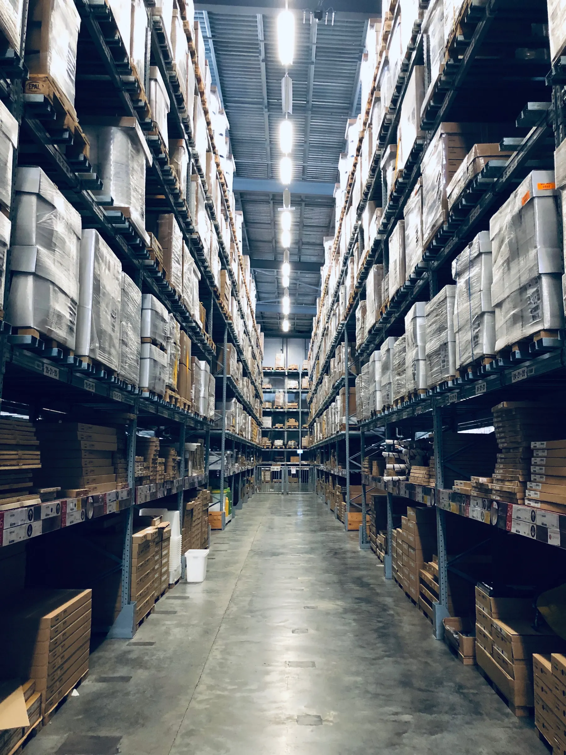 Warehouse aisle lined with tall storage racks